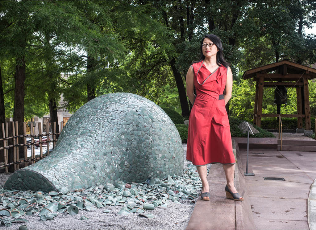 Artist Jean Shin poses with her installation Celadon Landscapes